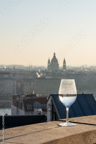 Refelction of St. Stephen basilica in wine glasses and vague silhouette in the background