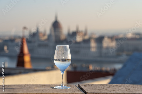 Reflection in wine glass of Hungary Paliament hazy figure in the background photo