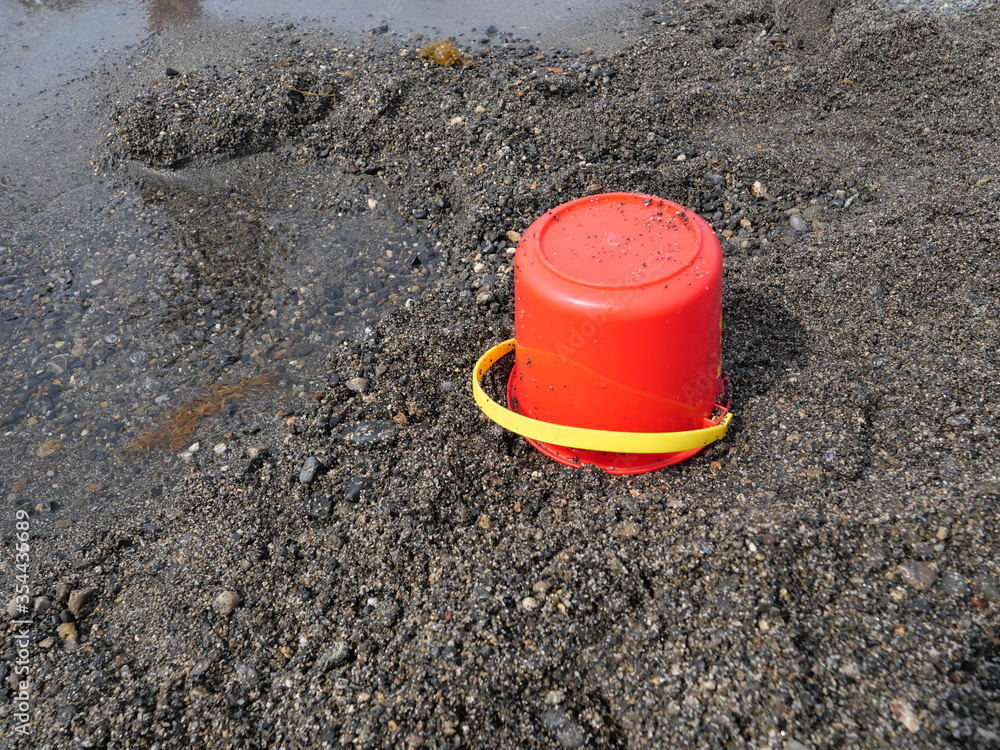 Sandy beach and a bucket for children Sandy beach and a bucket for children