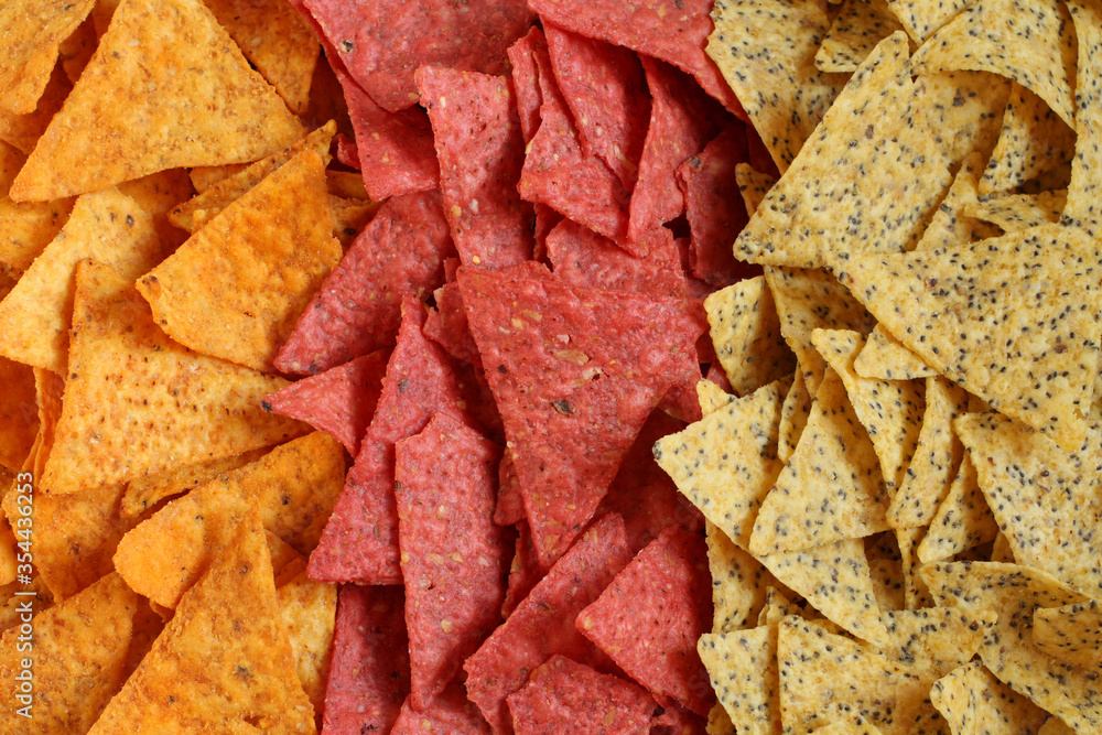 Food background of three kinds of tortilla chips: spicy nachos Mexican, with beetroot and with chia seeds Food background of three kinds of tortilla chips: spicy nachos Mexican, with beetroot and with chia seeds