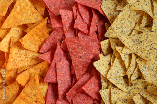 Food background of three kinds of tortilla chips  spicy nachos Mexican  with beetroot and with chia seeds