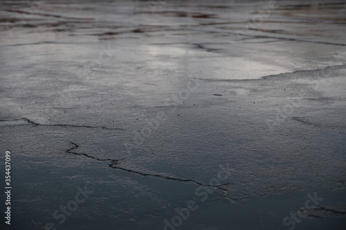 Obraz na plátne Sky reflection on wet concrete after rain with cracks