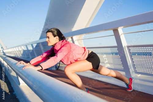 Young brunette woman in stylish sports wear