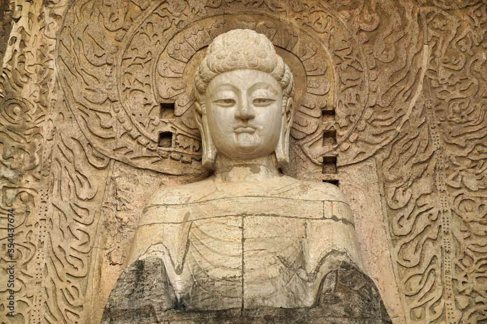 a complex of cave temples with a buddha carved into the rock