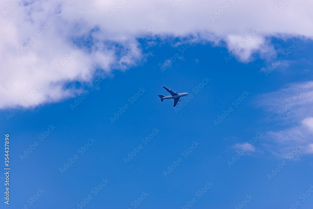 Commercial plane flight on blue sky