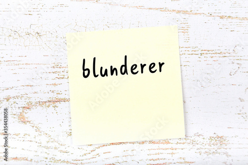 Yellow sheet of paper with word blunderer. Reminder concept photo