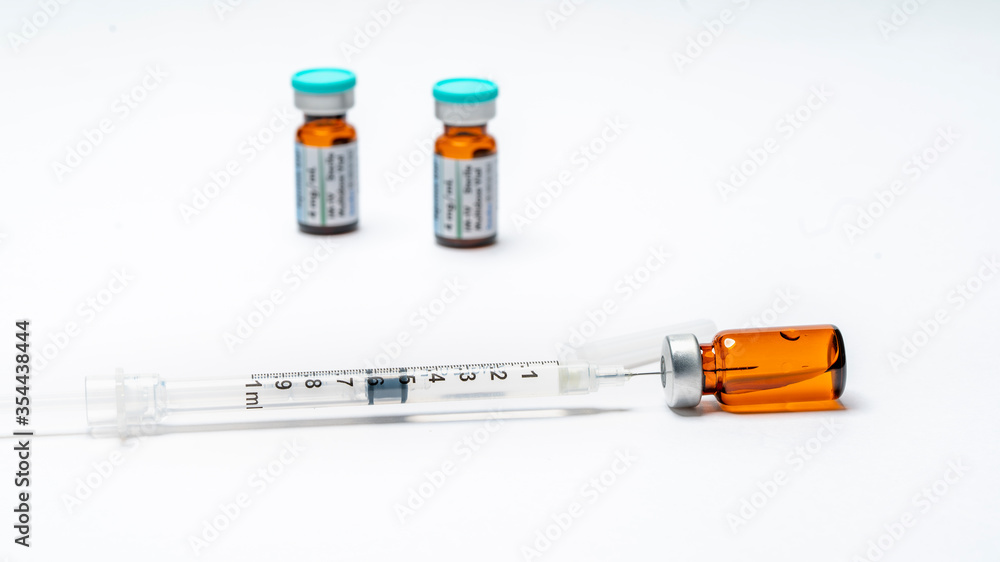 Close up of medicine vials and syringe. Close up of medicine vials and syringe.