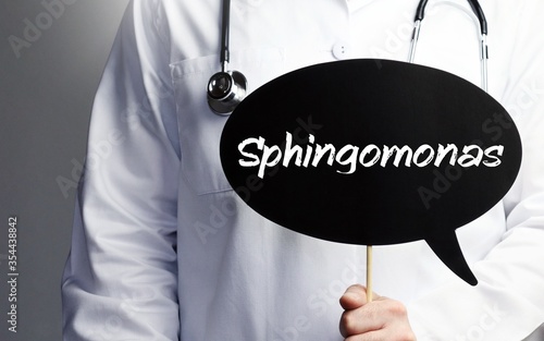Sphingomonas. Doctor with stethoscope holds speech bubble in hand. Text is on the sign. Healthcare, medicine photo