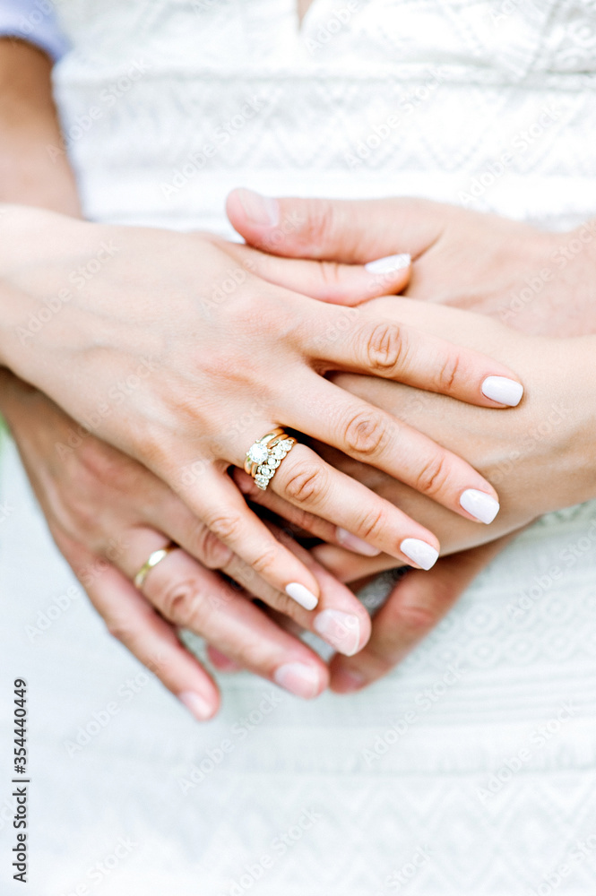 Hands of newlywed couple together. Wedding day. Man and woman hands holding together, wedding photo Hands of newlywed couple together. Wedding day. Man and woman hands holding together, wedding photo