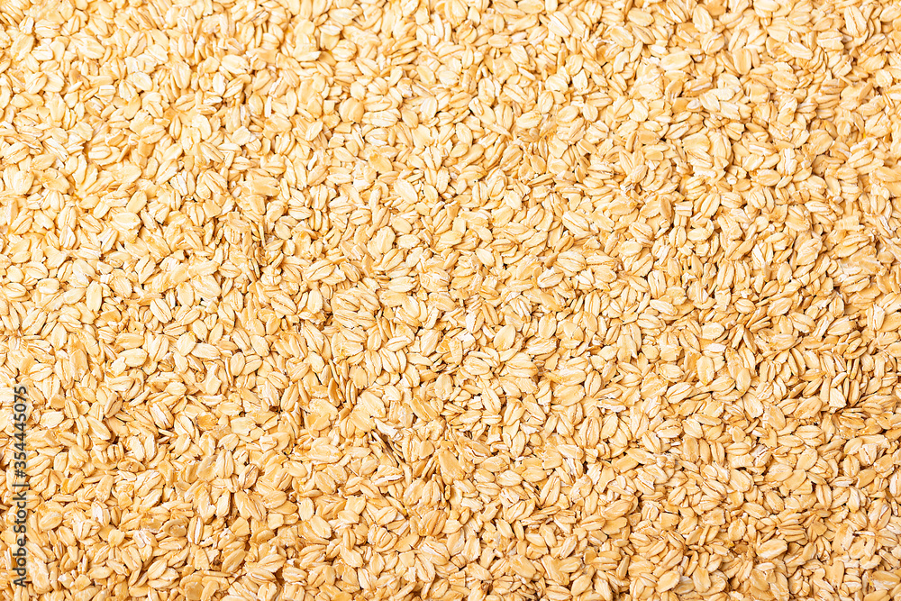 Background of raw oat flakes cereals from above Background of raw oat flakes cereals from above