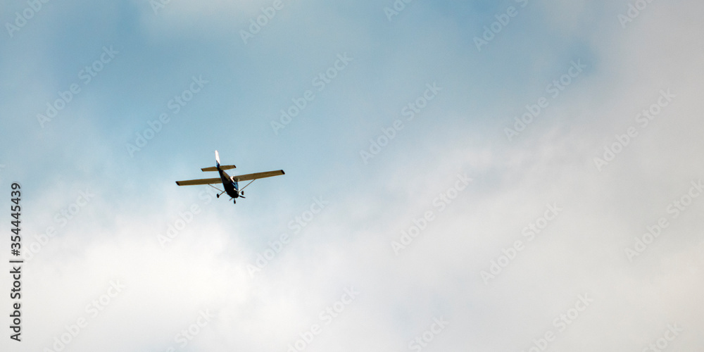 Small passenger plane flying in the blue sky Small passenger plane flying in the blue sky