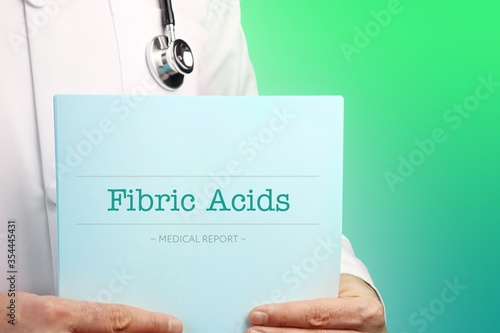 Fibric Acids. Doctor (male) with stethoscope holds medical report in his hands. Cutout. Green turquoise background. Text is on the documents. Healthcare/Medicine photo