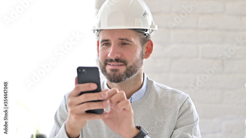 Young Engineer Browsing Internet on Smartphone