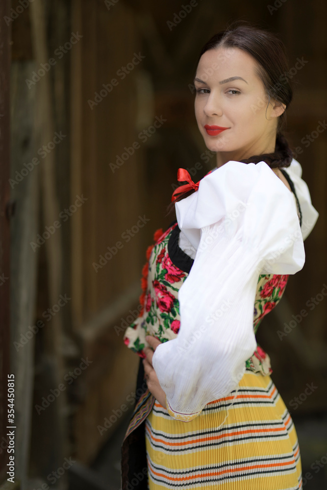Young beautiful slovak woman in traditional costume on summer Young beautiful slovak woman in traditional costume on summer