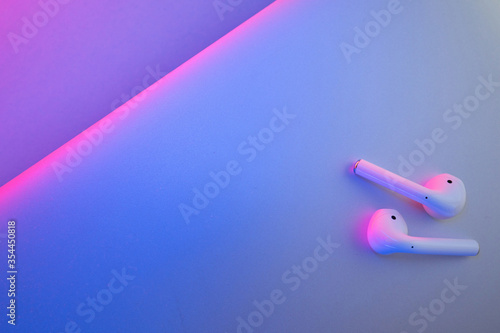 Wireless headphones on a colored background photo