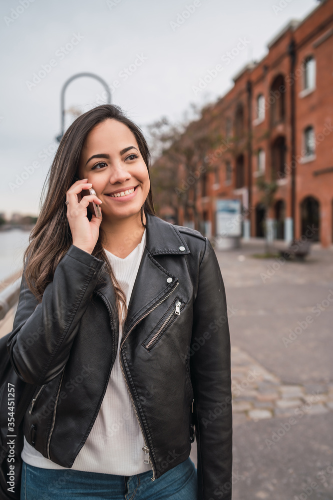 Latin woman talking on the phone. Latin woman talking on the phone.