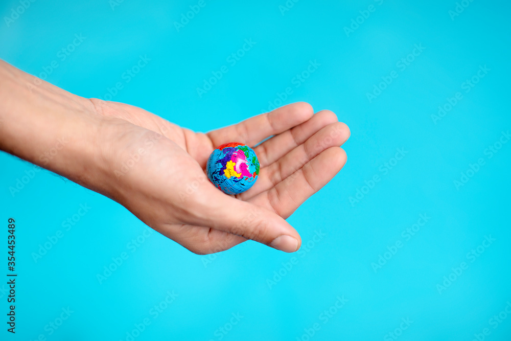 Fototapeta premium holding earth globe ball by hand