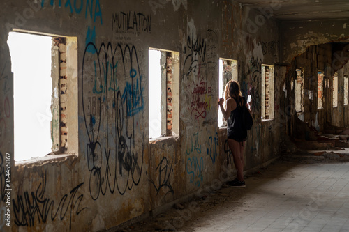 Young girl looking through the window photo