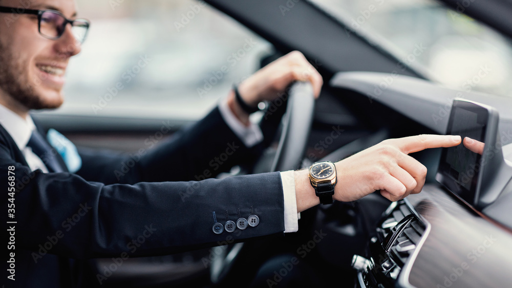 Businessman In Specs Sitting In New Auto Checking Dashboard