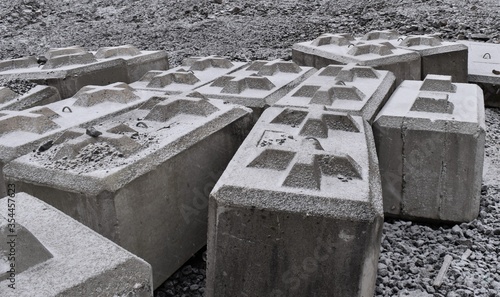 Large concrete blocks with crosses, covered in snow.  Used for retaining walls.  Interesting gothic cross pattern. photo