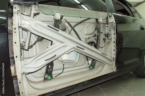 Mechanism of the electric window lifter installed on the car Fototapeta