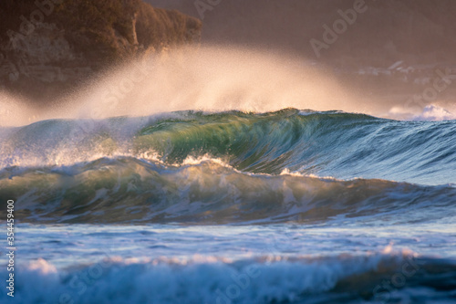 Waves breaking in Japan. The Pacific Ocean & its waves often generated by a Typhoon. The stunning coastline of Japan, Travellers like to visit the beach & watch the swell turn into waves & break