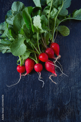 fresh radish on a dark wooden surface
