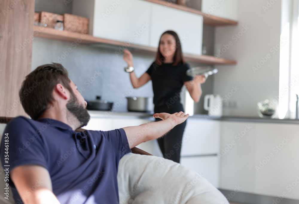 Happy young couple have fun in modern wooden kitchen Happy young couple have fun in modern wooden kitchen