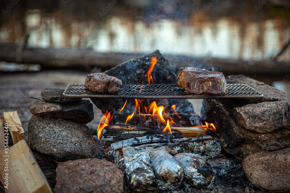 Cooking a Tomahawk Steak and Ribeye over an open fire while camping Cooking a Tomahawk Steak and Ribeye over an open fire while camping