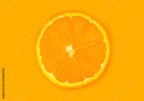 Orange fruit. Round orange slice isolate on orange background. Top view, flat lay.