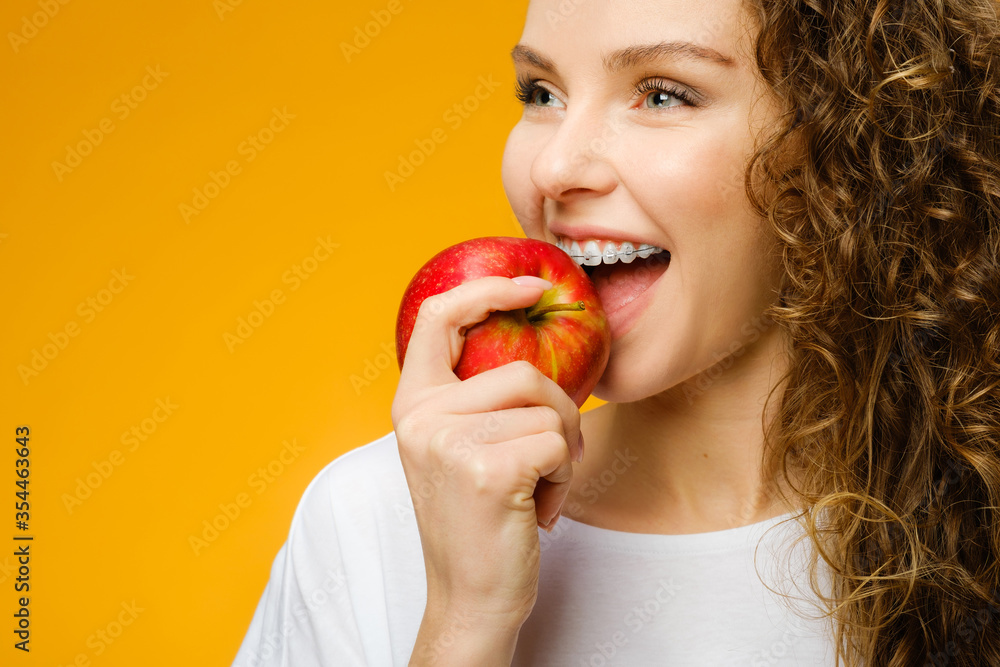 Pretty curly girl with red apple