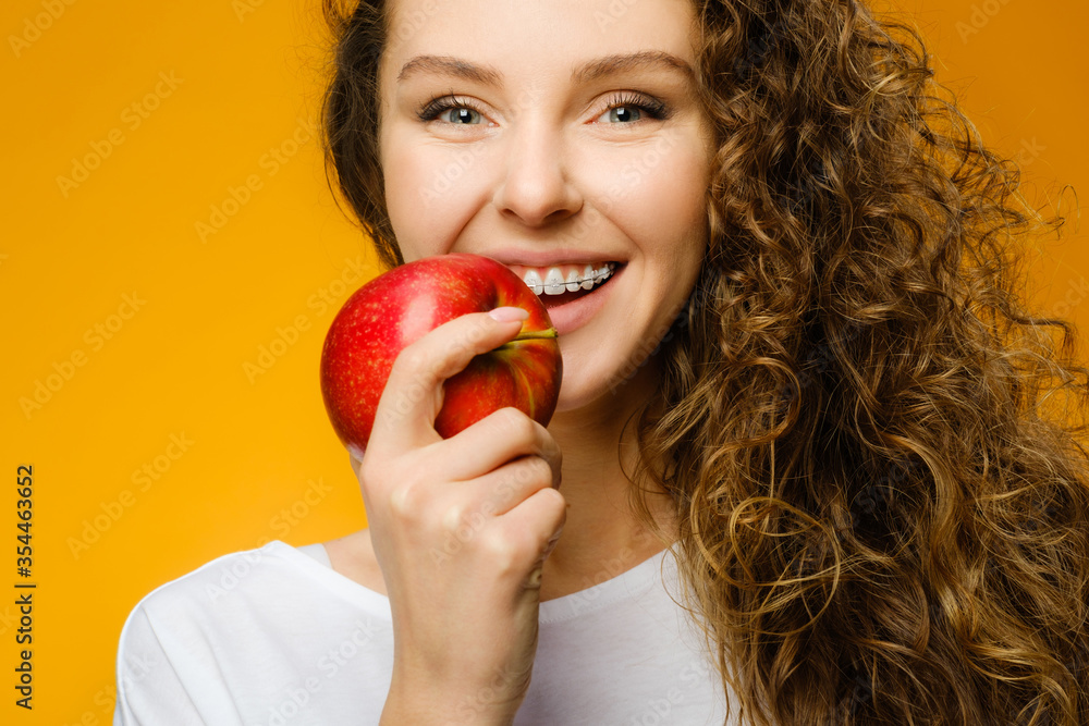 Pretty curly girl with red apple Pretty curly girl with red apple