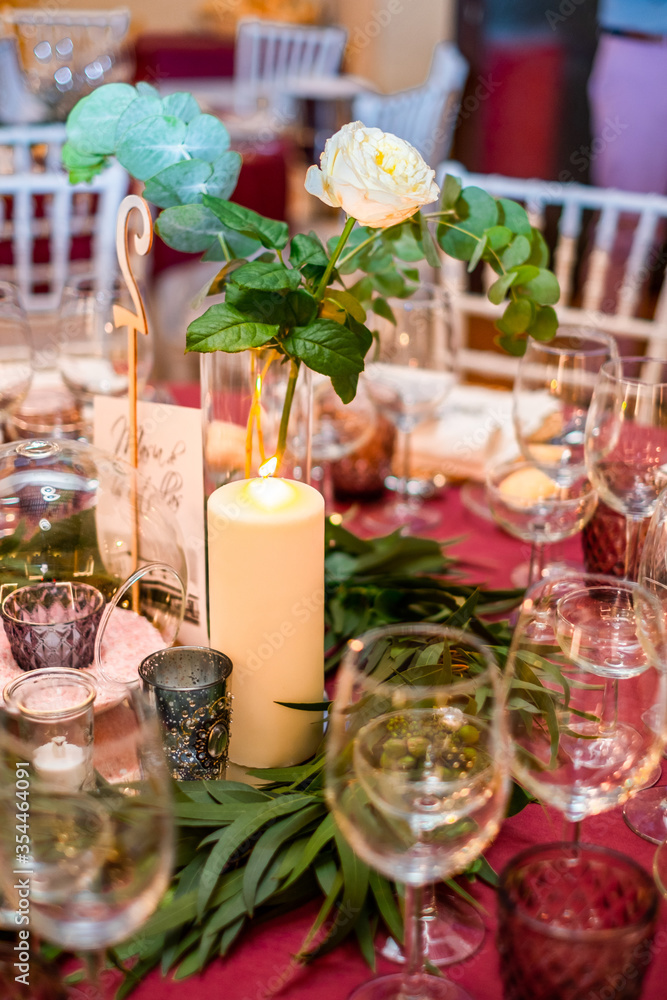 Close-up of candles standing on a table at a wedding reception. 