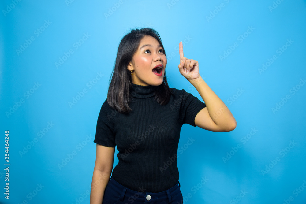 Fototapeta premium Portrait of Young beautiful asian women wearing black turtle neck shirt with blue isolated background