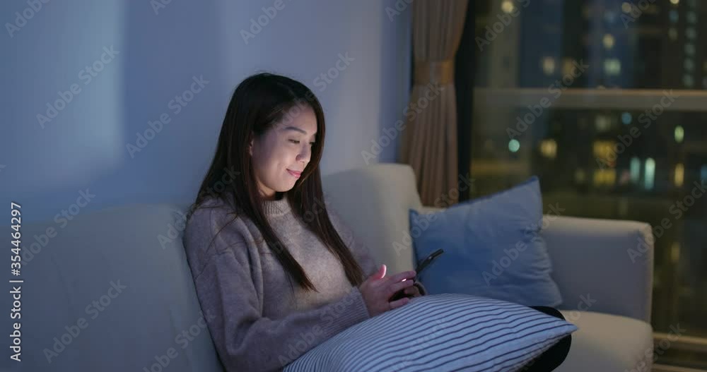 Woman work on cellphone at home in evening Woman work on cellphone at home in evening