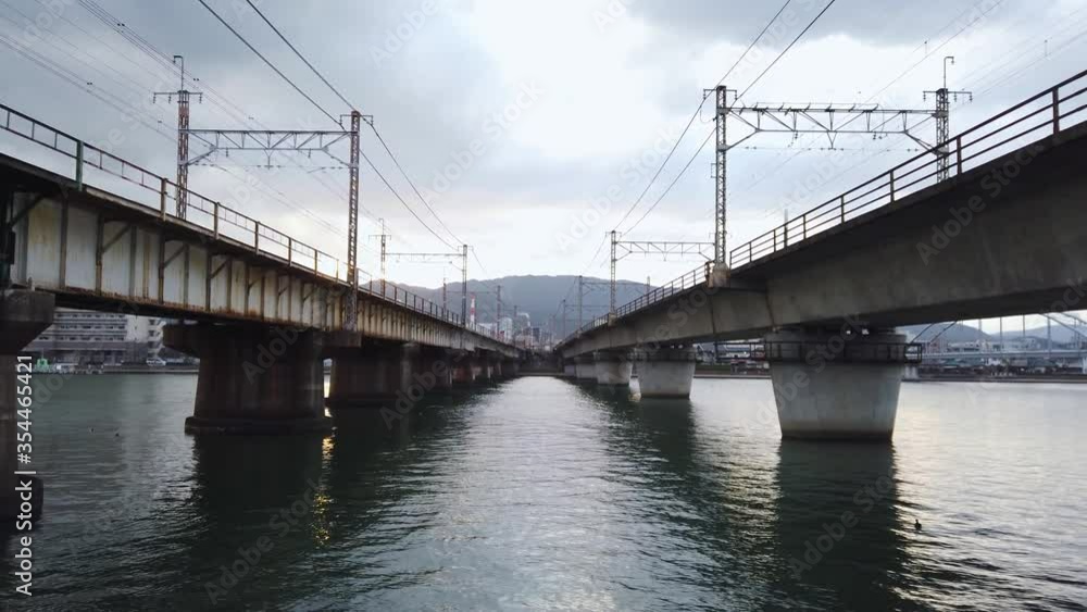 Two Railway bridges crossing river, slow tilt up Two Railway bridges crossing river, slow tilt up