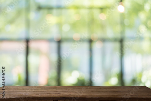 empty wooden table with soft focus background bokeh.