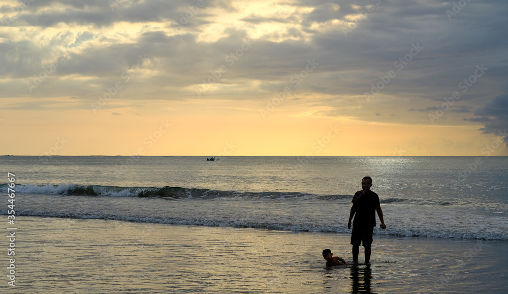 Fototapeta premium Silhouette of a man at Sunset Beach, Bali during sunset