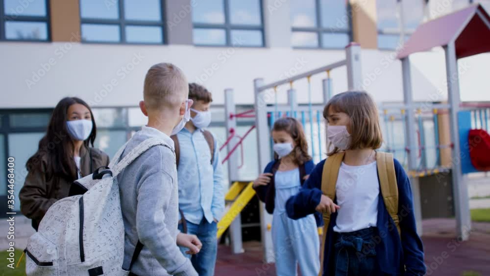 Children with face mask going back to school after covid-19 lockdown, greeting. Children with face mask going back to school after covid-19 lockdown, greeting.