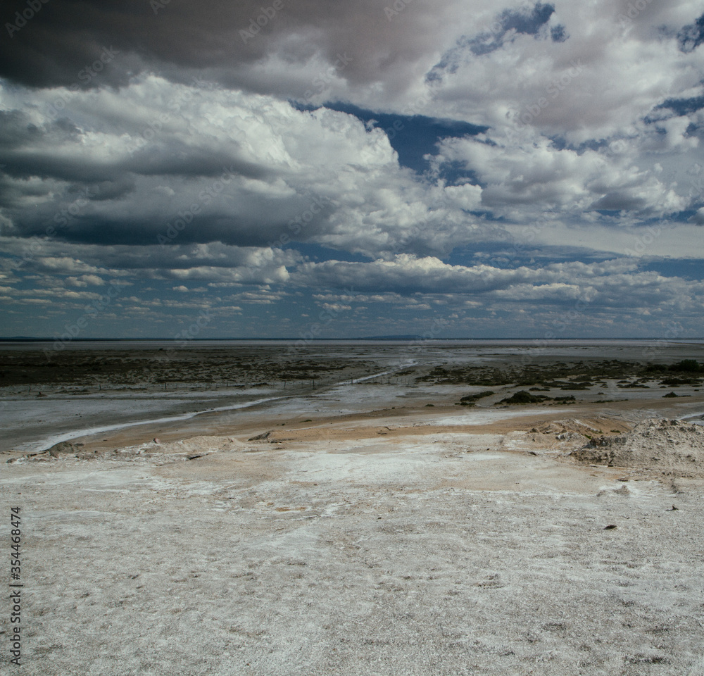 Natural Salt flats. Industry and Salt mining. Saltworks and salt natural fields under a dramatic and stormy sky Natural Salt flats. Industry and Salt mining. Saltworks and salt natural fields under a dramatic and stormy sky