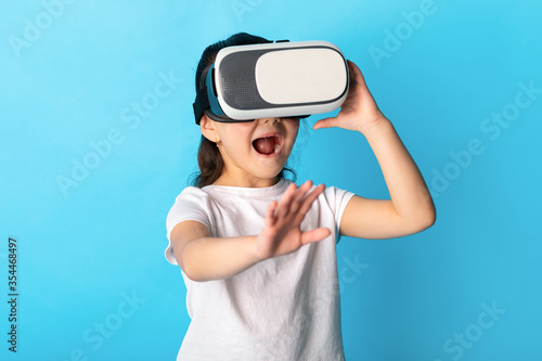 Little girl wearing virtual reality goggles at studio