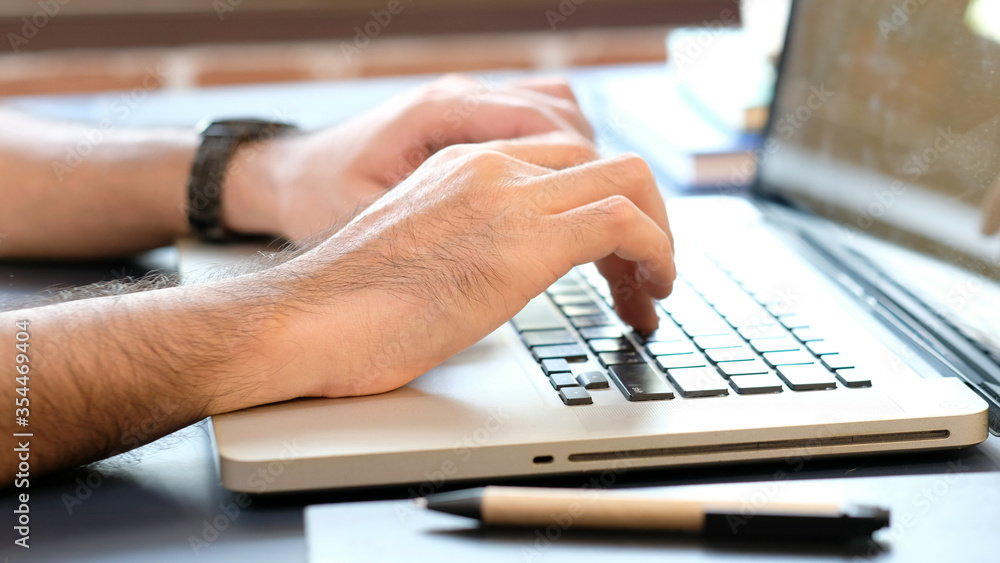 Close up of man hand typing keyboard laptop computer when work and study from home white online technology for the internet of things concept Close up of man hand typing keyboard laptop computer when work and study from home white online technology for the internet of things concept