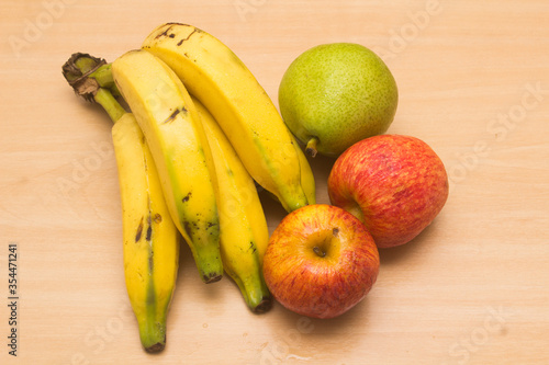 Colorful fresh summer fruits on yellow wooden background  healthy organic food on table  detox vitamin nutrition for health care  top close up view  copy space