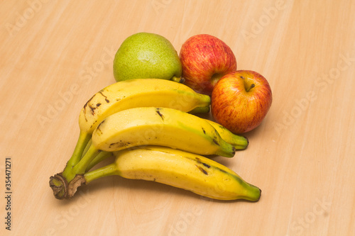 Colorful fresh summer fruits on yellow wooden background, healthy organic food on table, detox vitamin nutrition for health care, top close up view, copy space