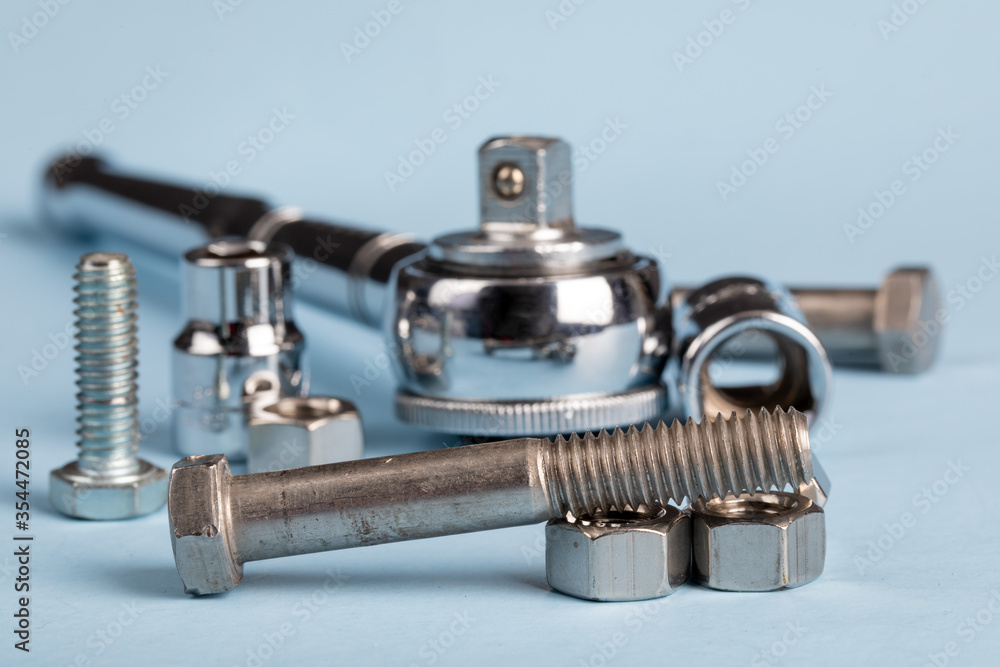 a mechanic's ratchet socket wrench with an assortment of nuts and bolts a mechanic's ratchet socket wrench with an assortment of nuts and bolts
