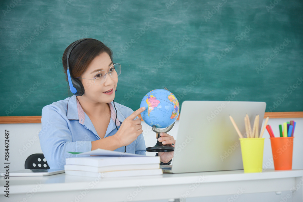 Asian teachers forced to teach school children via online under coronavirus covid-19 lock down.Distance teaching ,online school concept. Asian teachers forced to teach school children via online under coronavirus covid-19 lock down.Distance teaching ,online school concept.
