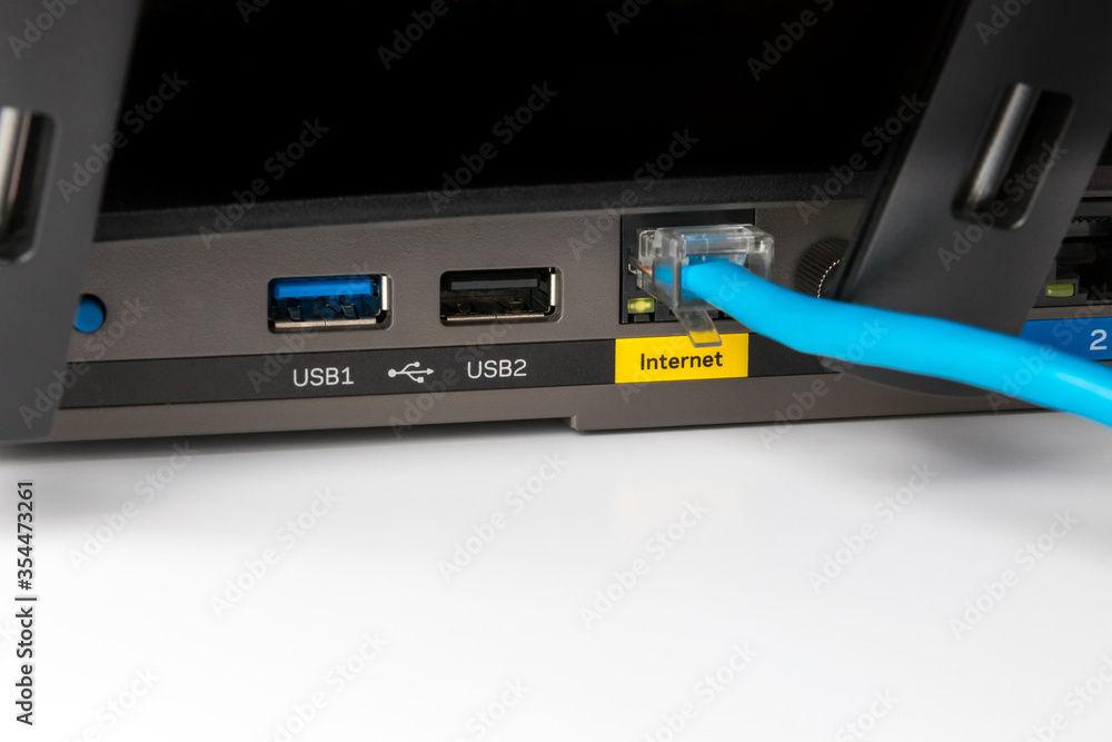 Closeup of wireless router internet connection port and cable. Concept of internet data, e-commerce, and e-learning
