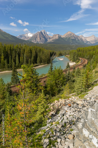 Railroad track through the Canadian Rockies along river
