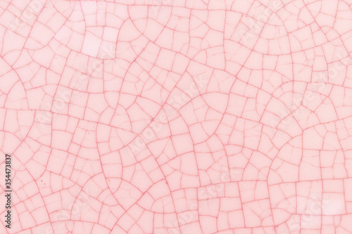 Pink and white crack ceramic tile. Pale red color of glazed tile texture abstract background. Texture of  rose crackle glass mosaic tile.