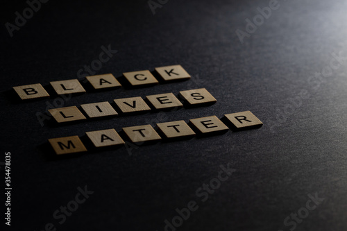 "Black lives matter" written on wood blocks. Dark Background